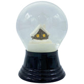 A decorative snow globe containing a small house, encapsulated in a snowy environment.